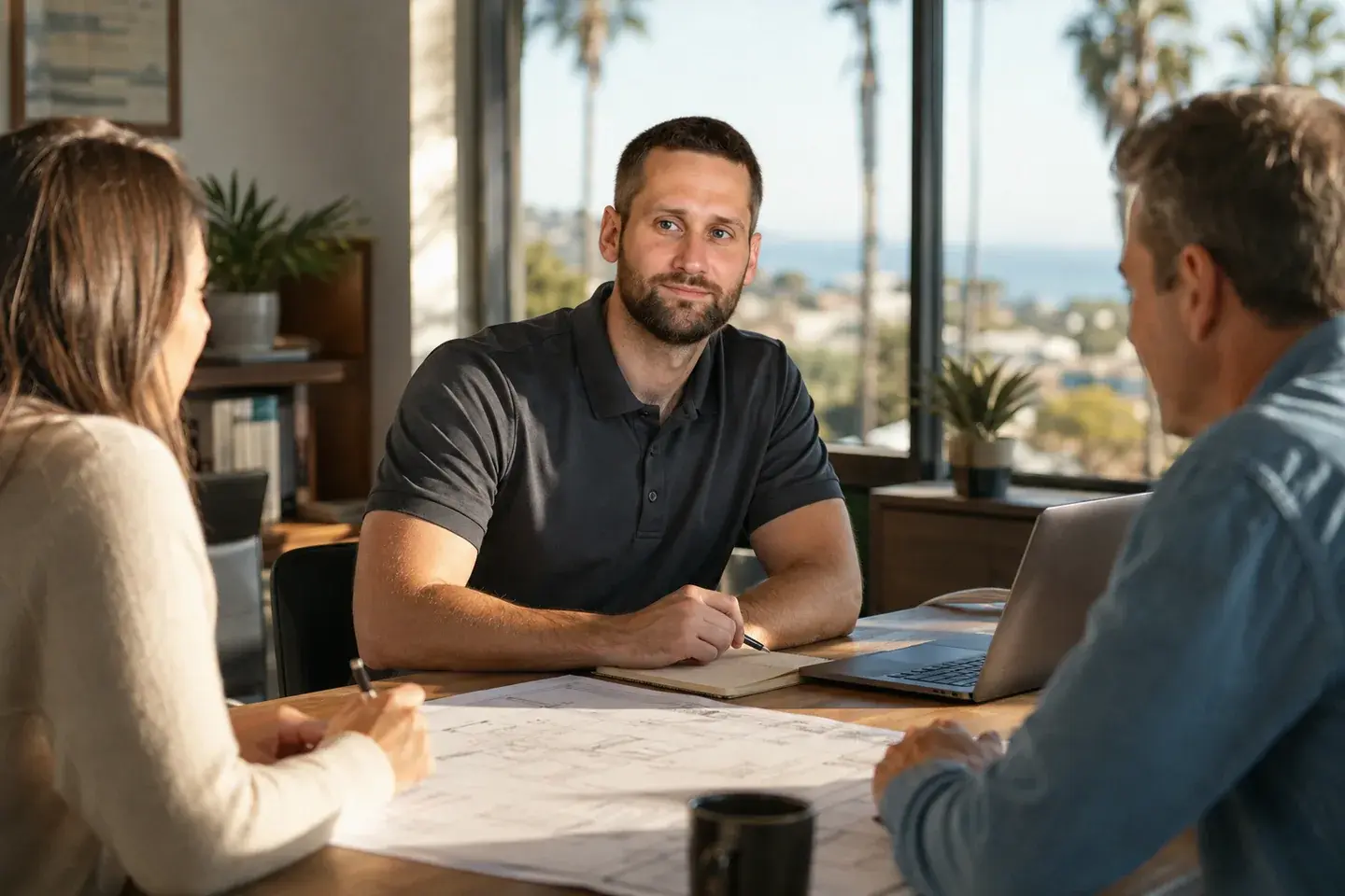 Illustrated scene of Matt working through project plans with colleagues in a sunlit California office